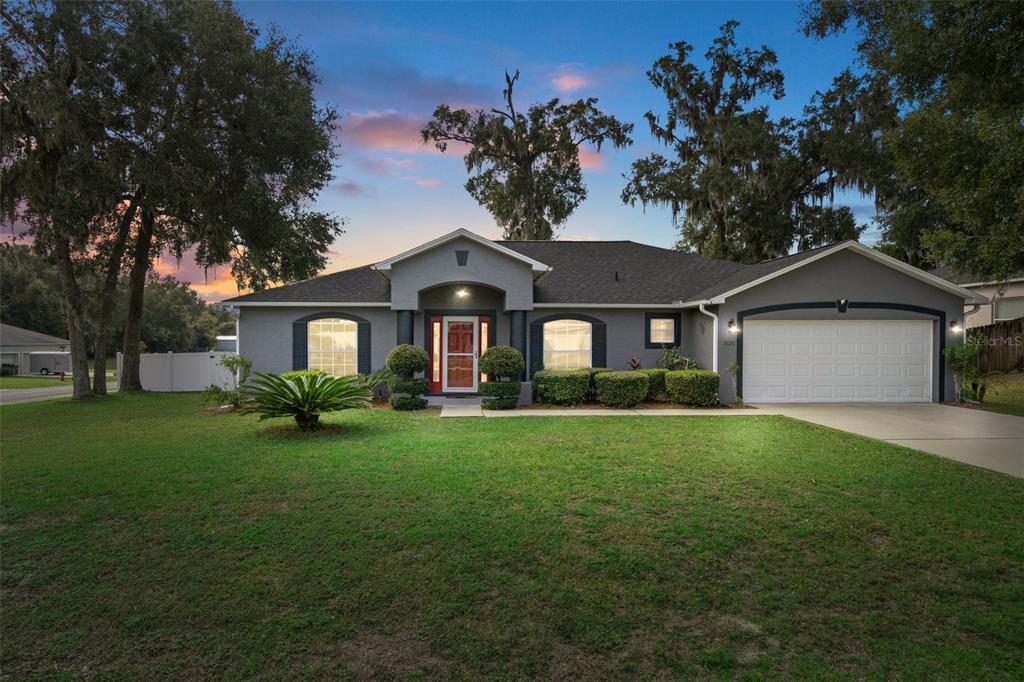 a front view of a house with a yard and garage