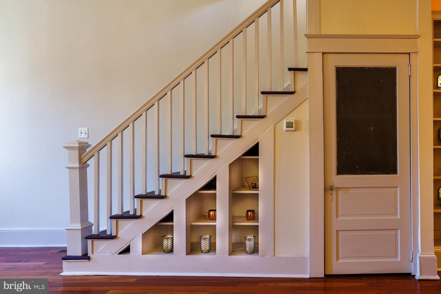 a view of entryway with wooden floor and front door