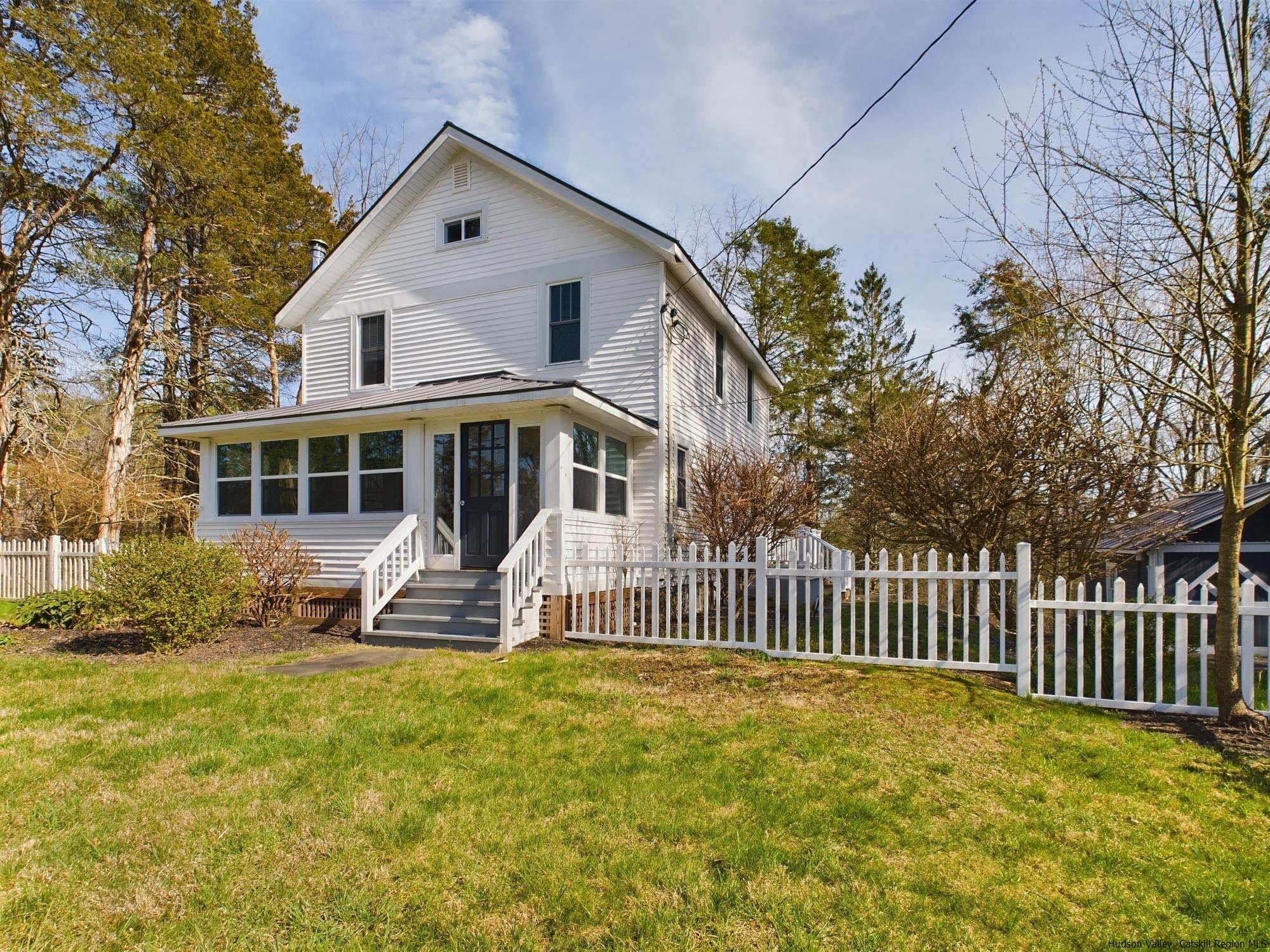 a front view of a house with a garden