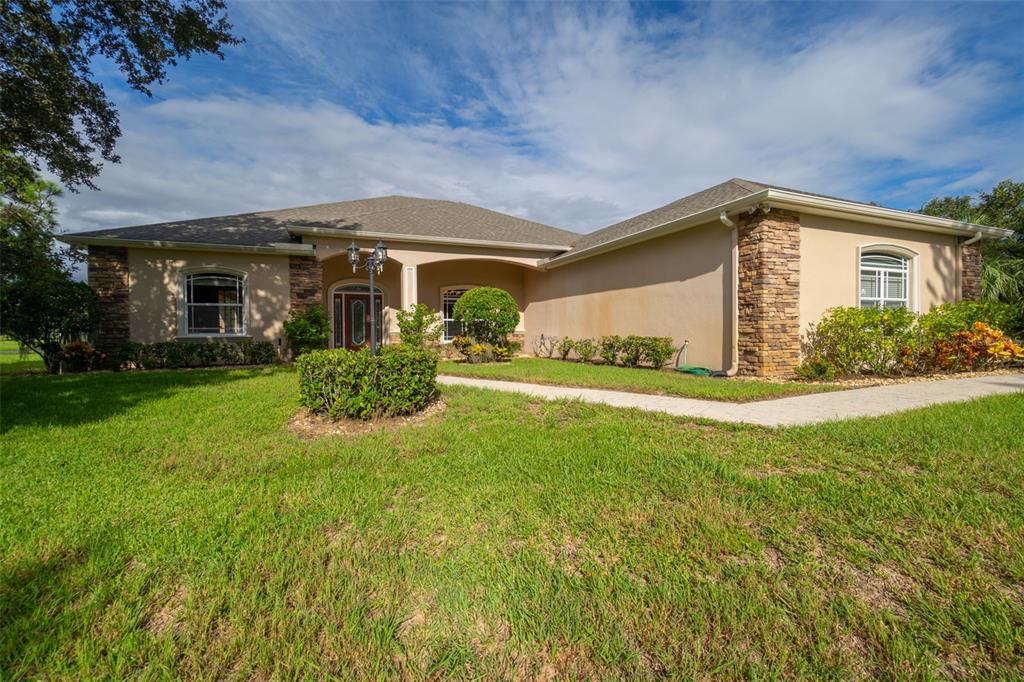 a front view of house with yard and green space