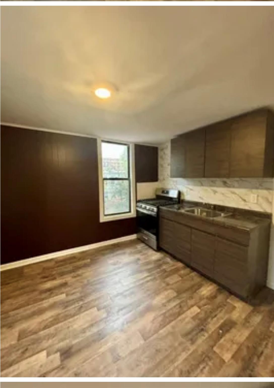 a view of kitchen with wooden floor