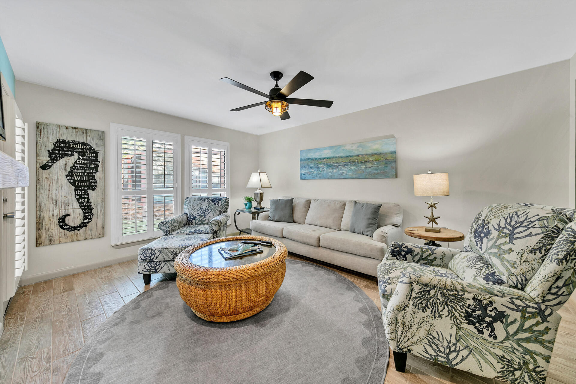 a living room with furniture a lamp and a large window