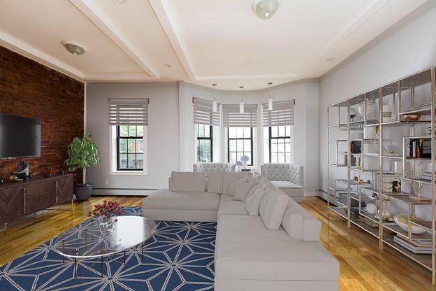 a living room with furniture windows and a flat screen tv