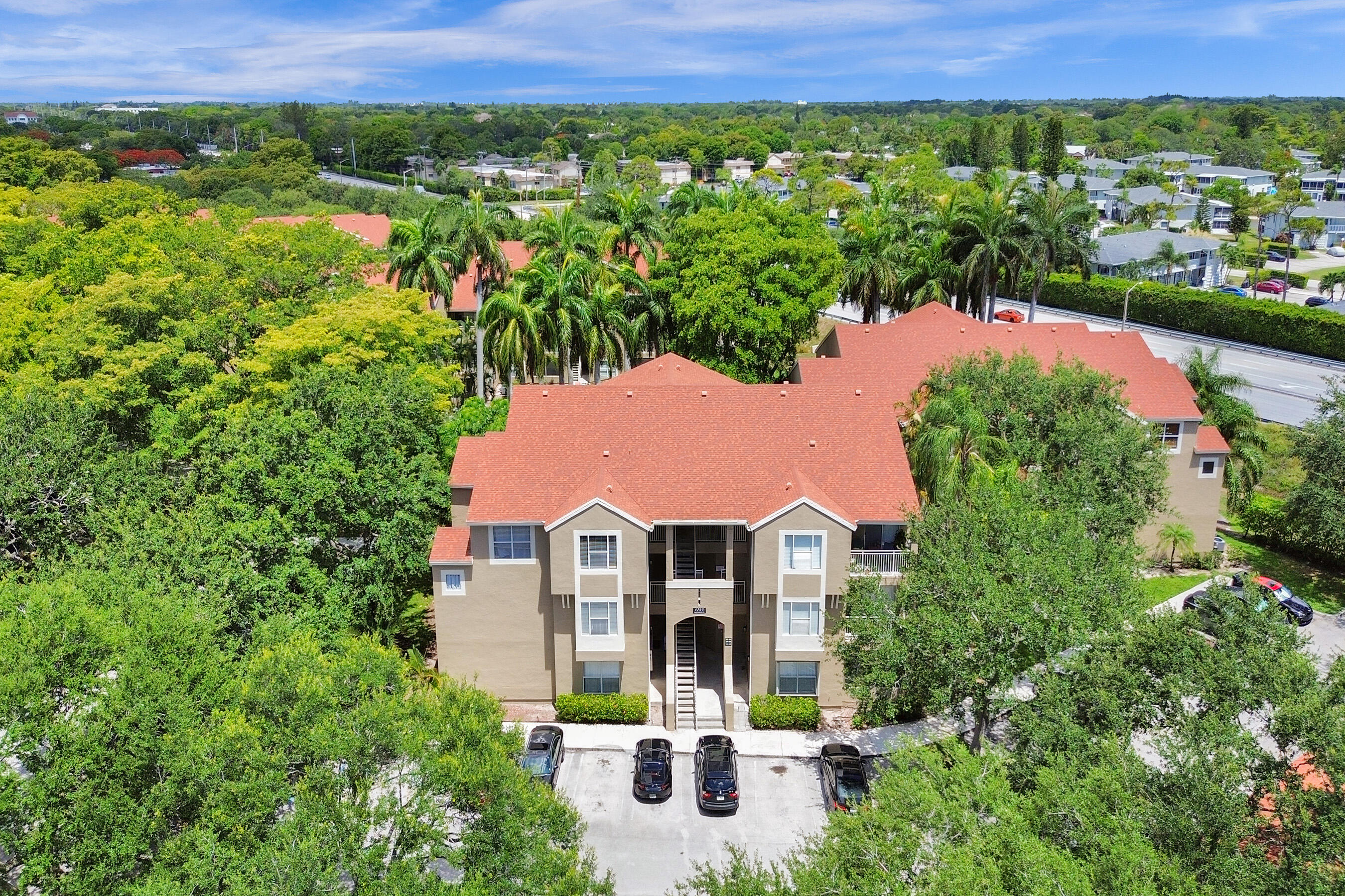 an aerial view of a house with a yard and lake view