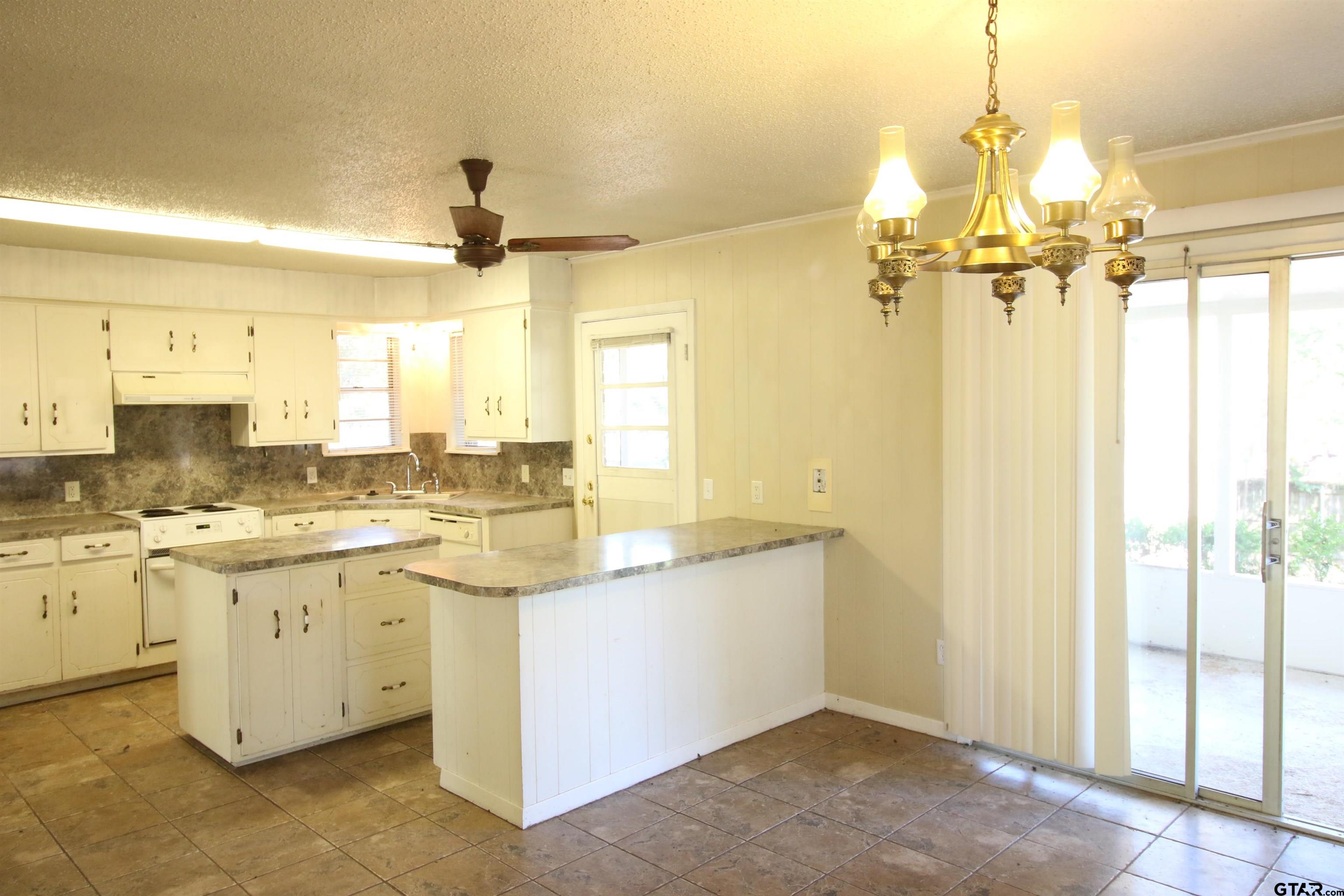 a bathroom with a granite countertop sink a mirror and a shower