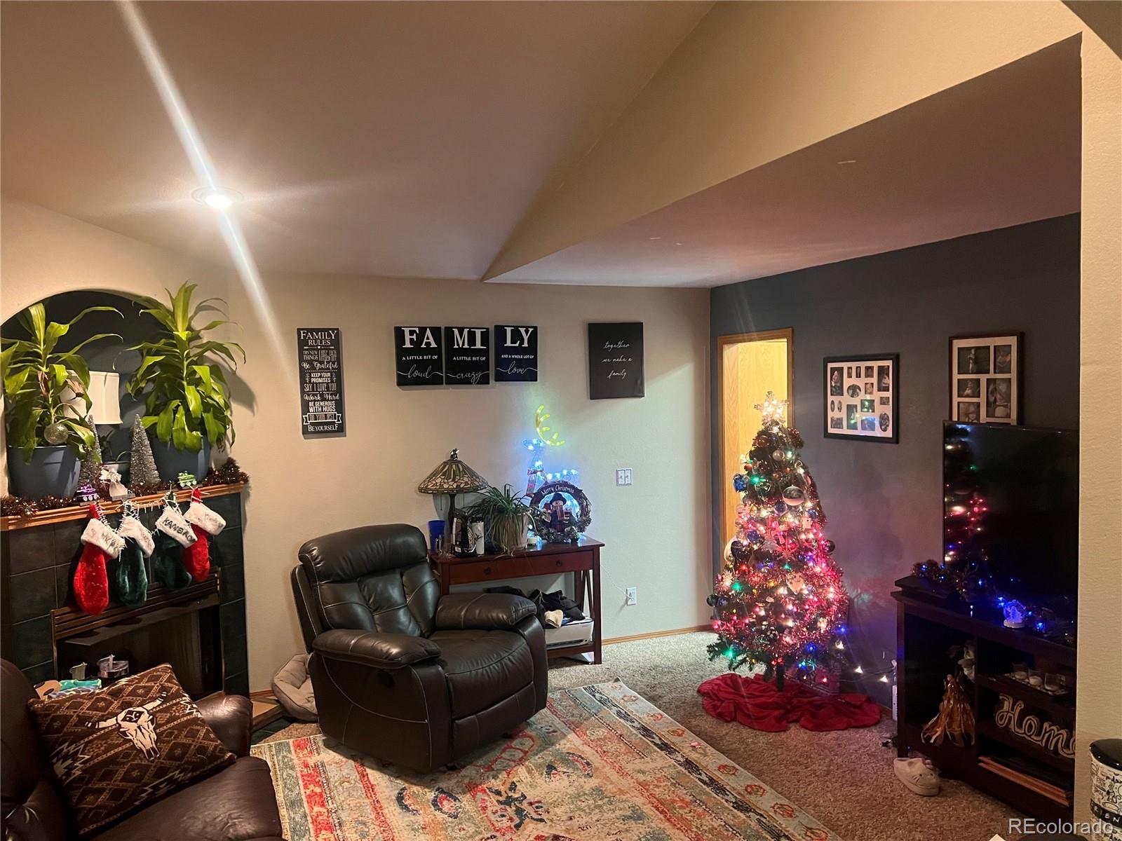 a living room with furniture and flowers