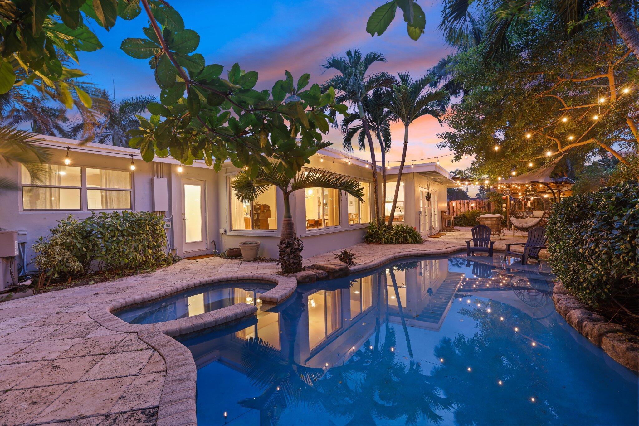 a view of a house with backyard and sitting area