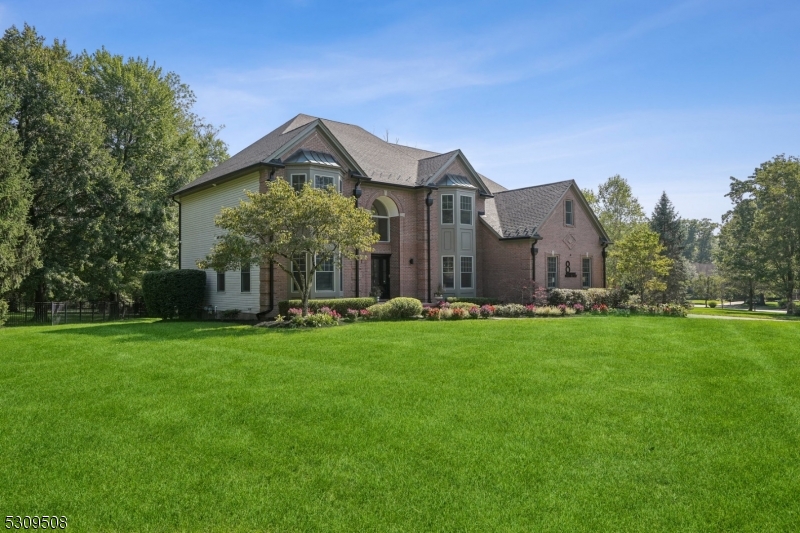 a front view of house with yard and green space