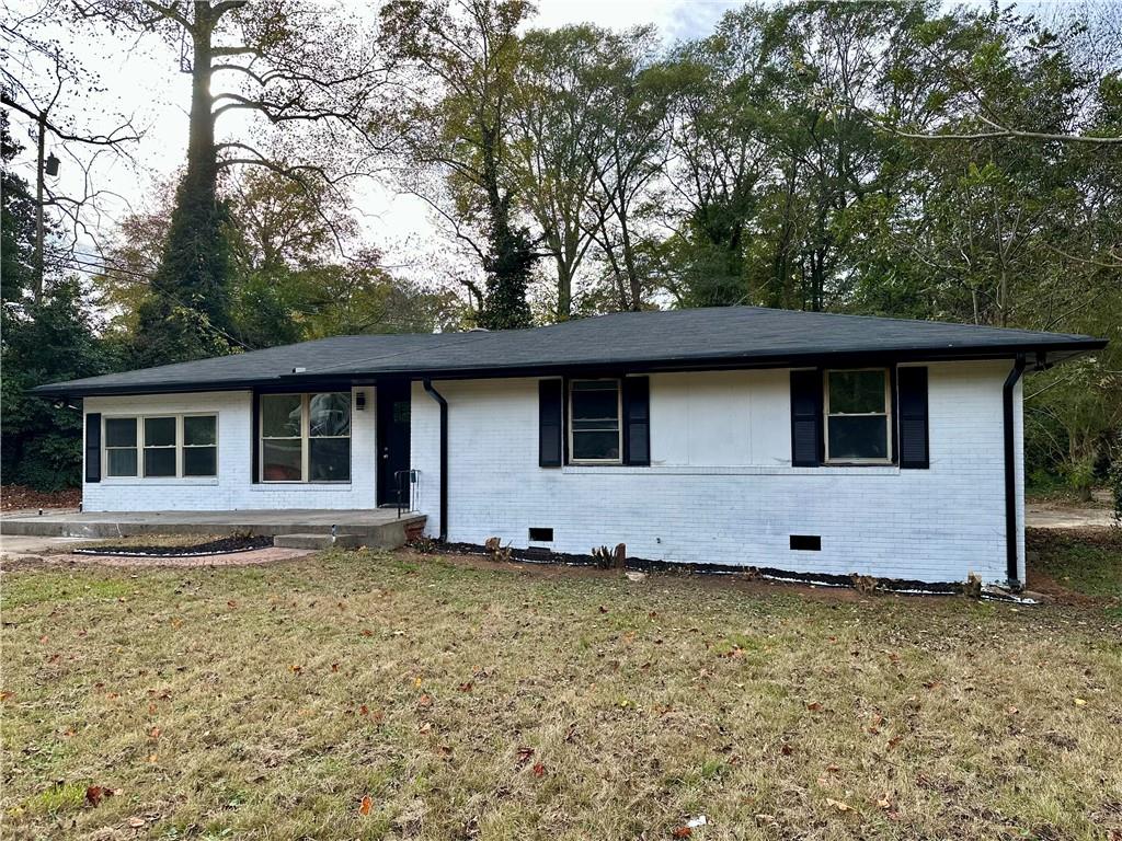 a front view of house with yard space and wooden fence