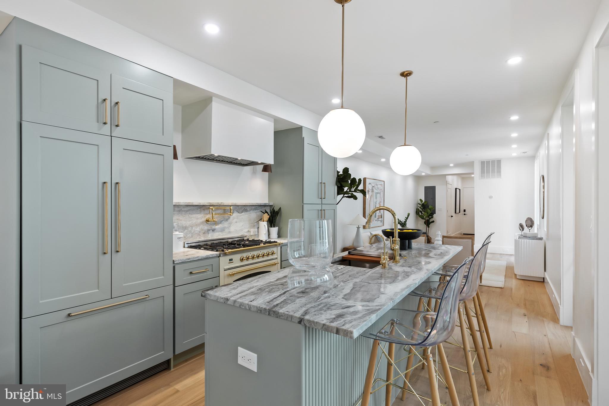 a kitchen with a table chairs and white cabinets