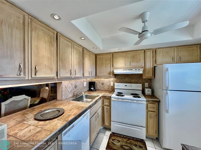 a kitchen with a stove a sink and a refrigerator