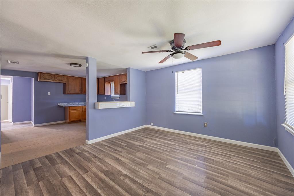 a bedroom with a bed and a chandelier fan