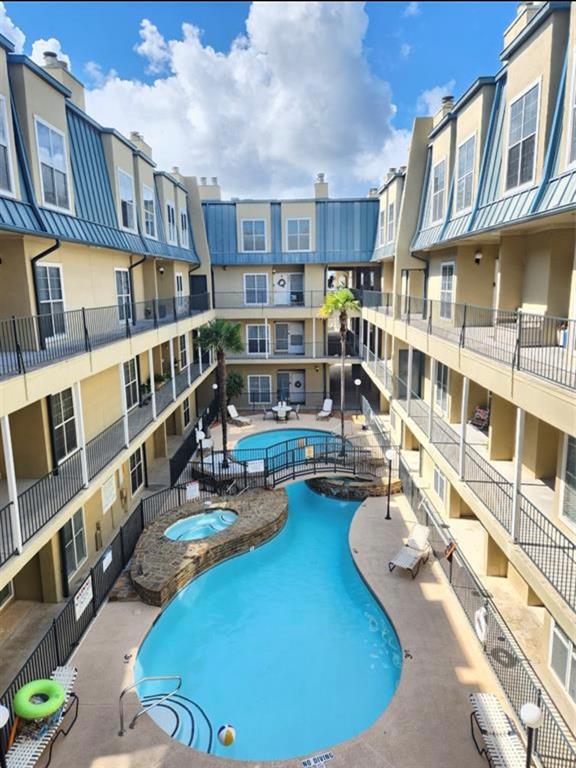 a view of a swimming pool with outdoor seating