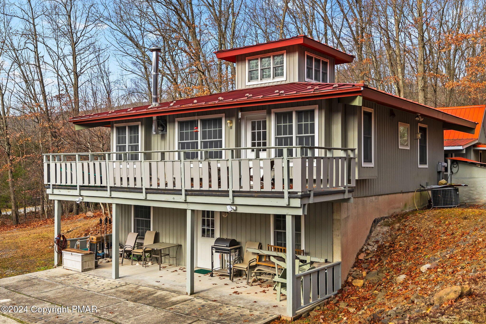 a view of a house with backyard porch and sitting area