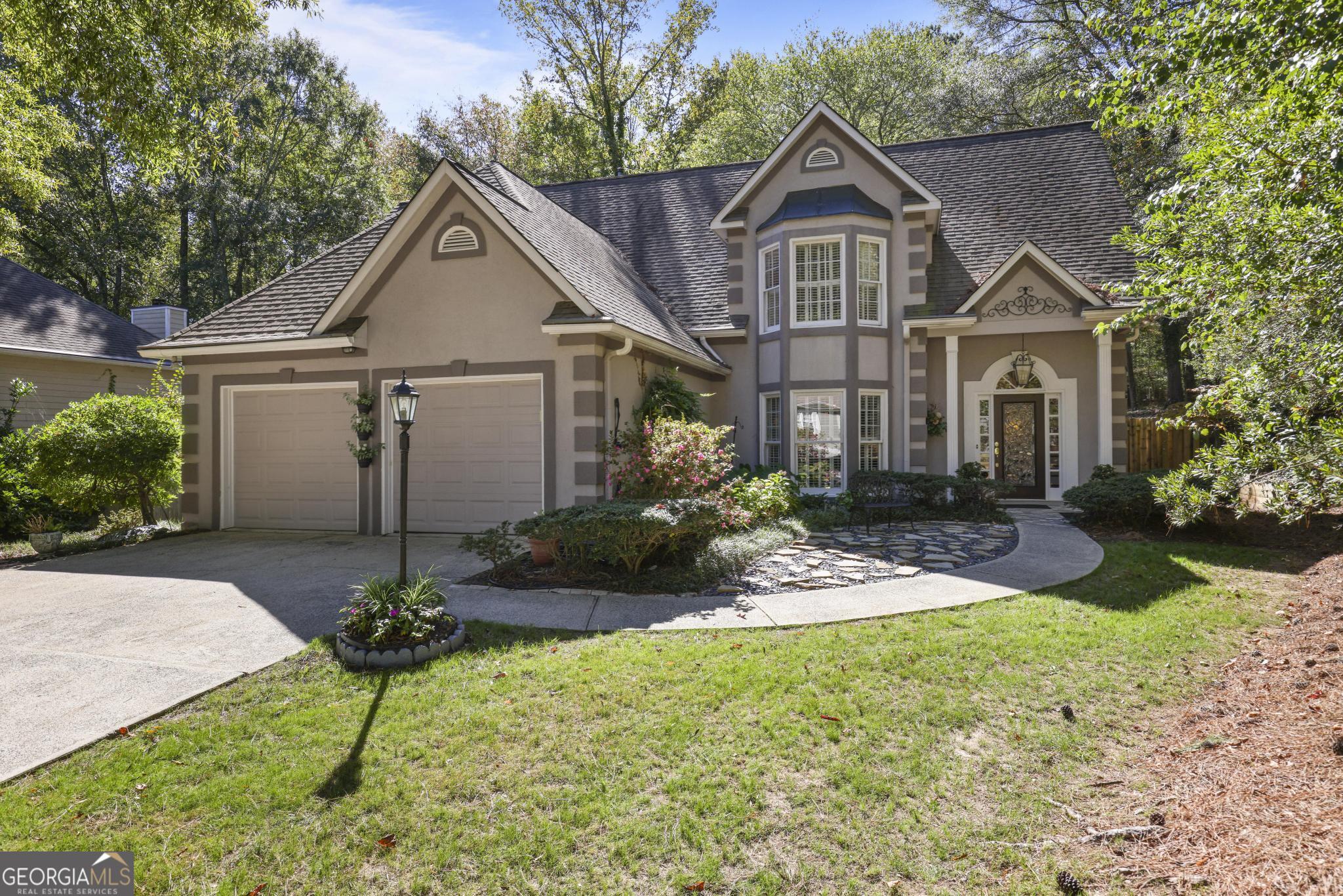 a front view of a house with a yard and garage