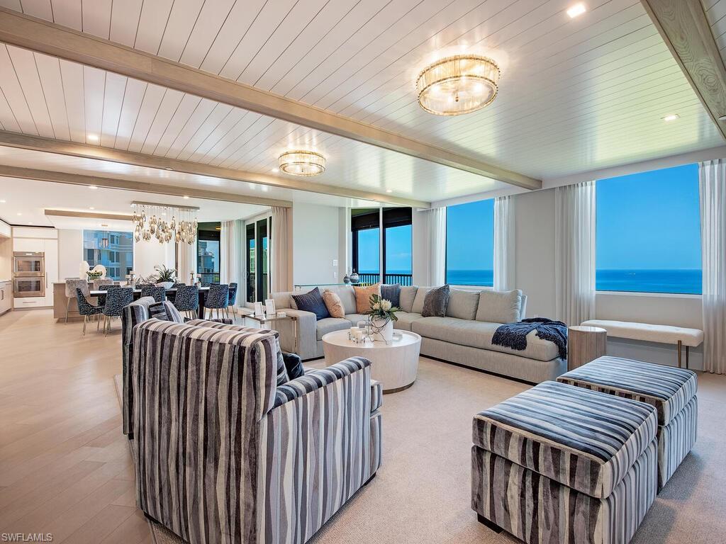 a living room with furniture and a chandelier