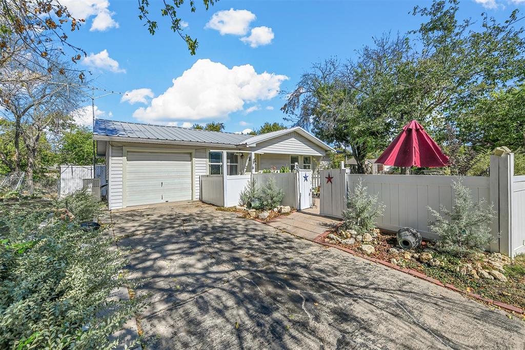 a backyard of a house with table and chairs