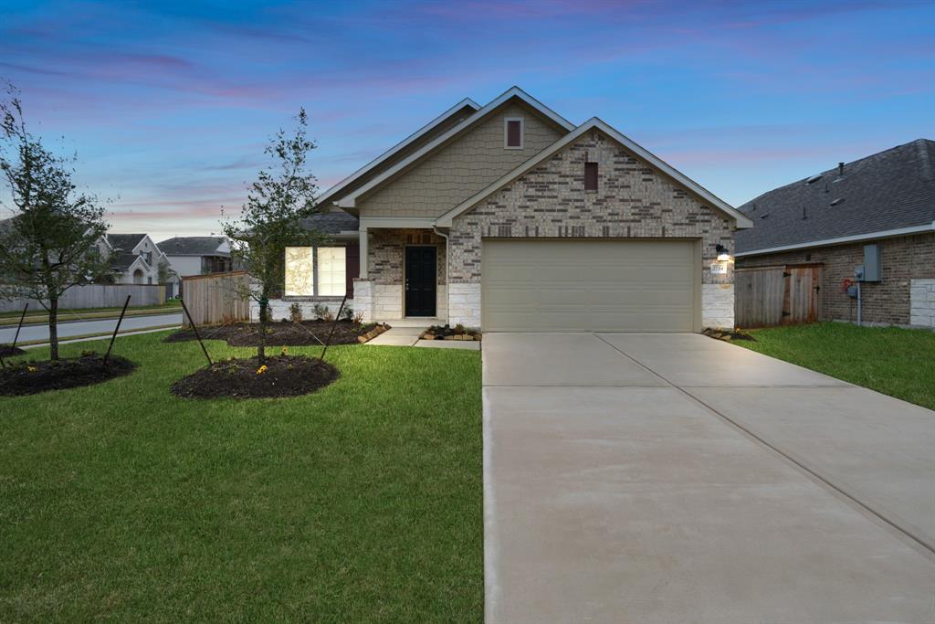 a front view of house with a garden