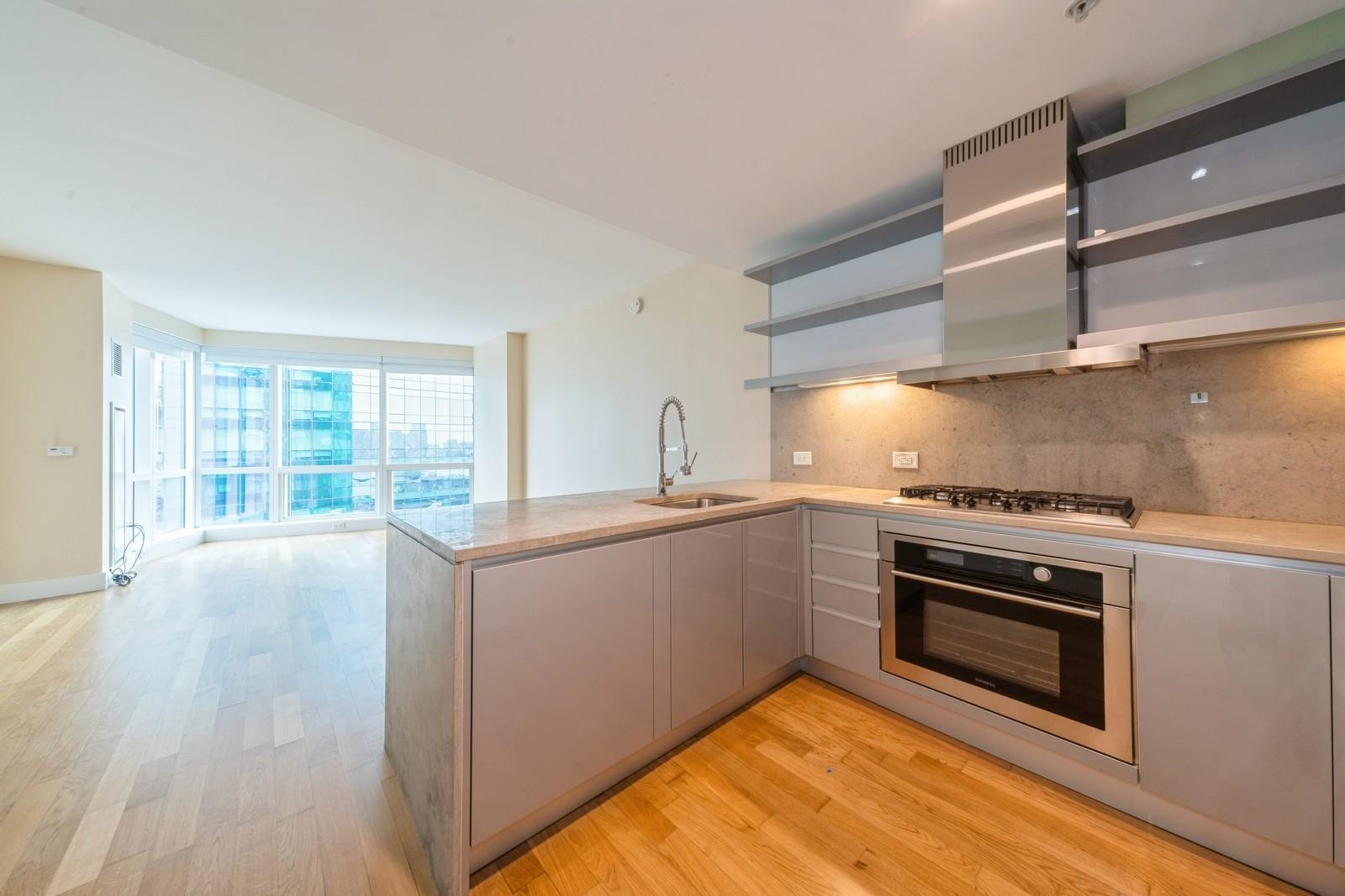 a kitchen with stainless steel appliances granite countertop a stove and a sink