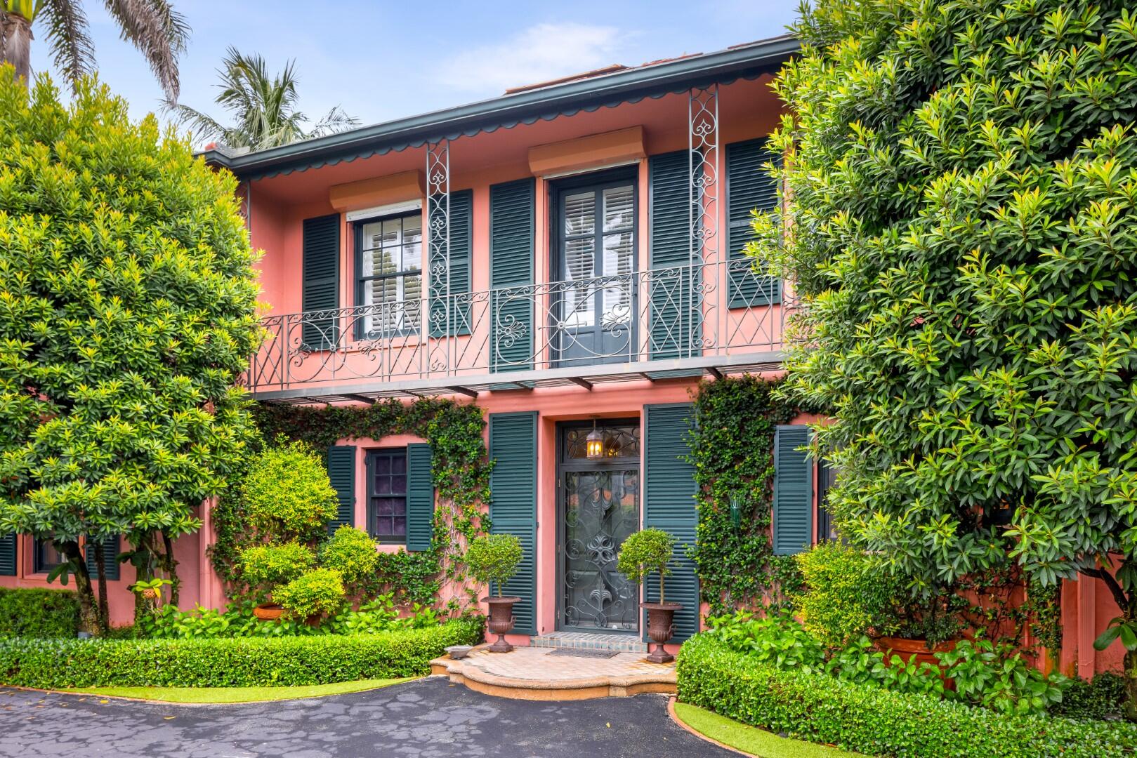 front view of a brick house with a yard