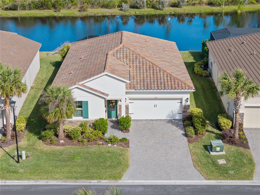 a aerial view of a house with a yard and a fountain