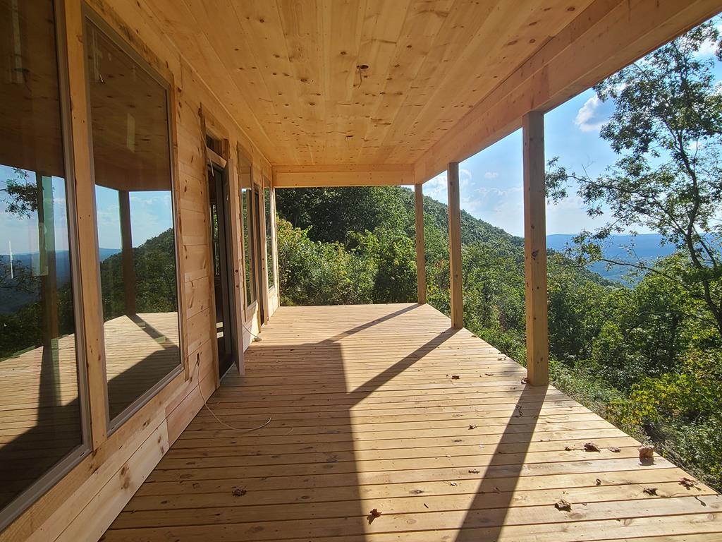 a porch with wooden floor and outdoor space