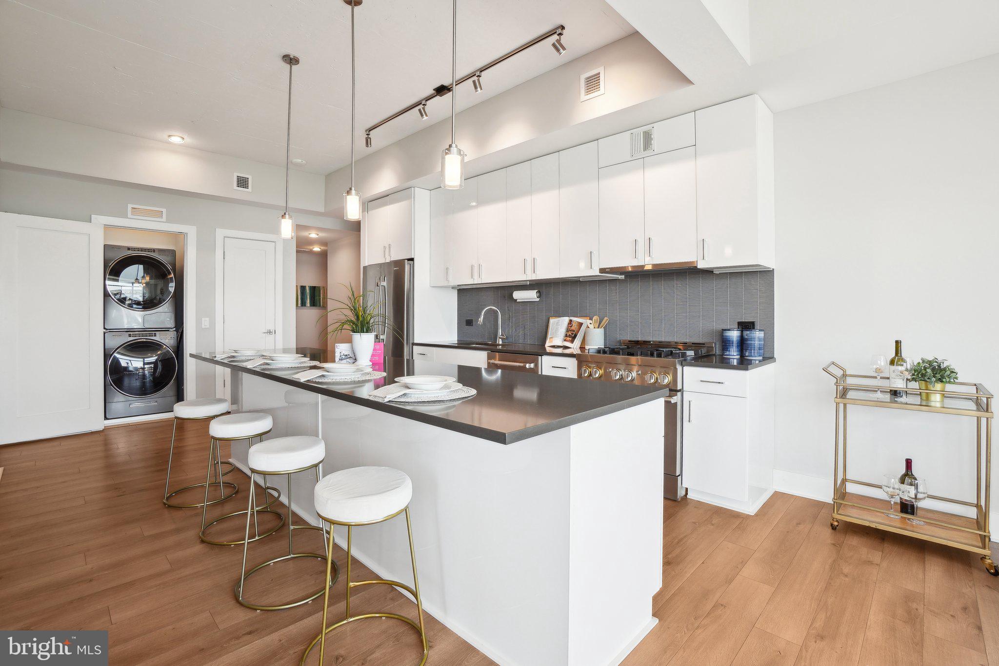 a kitchen with stainless steel appliances kitchen island granite countertop a sink and cabinets