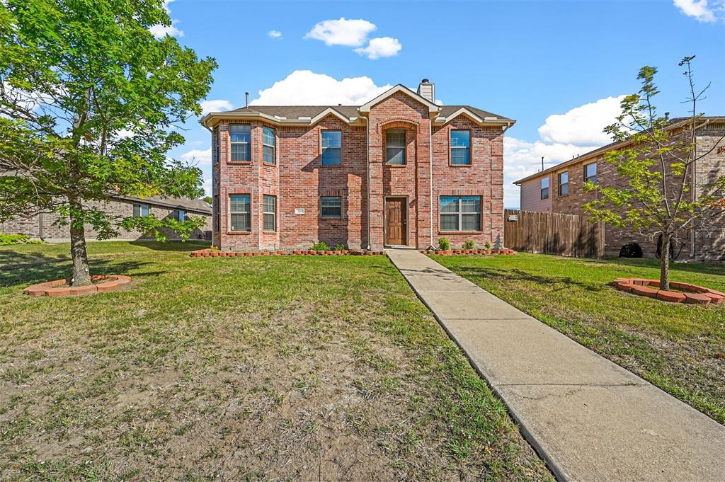 a front view of a house with a yard