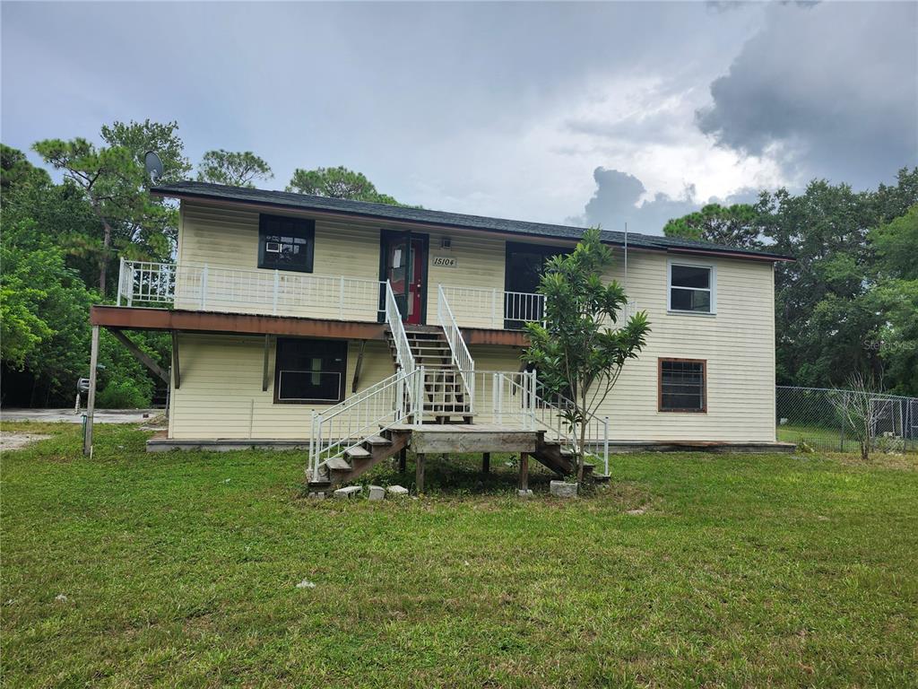 a front view of house with yard and trees