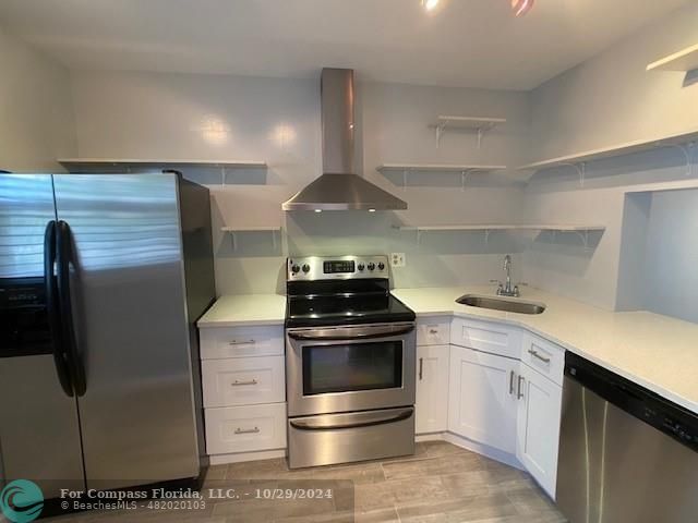 a kitchen with stainless steel appliances and white cabinets