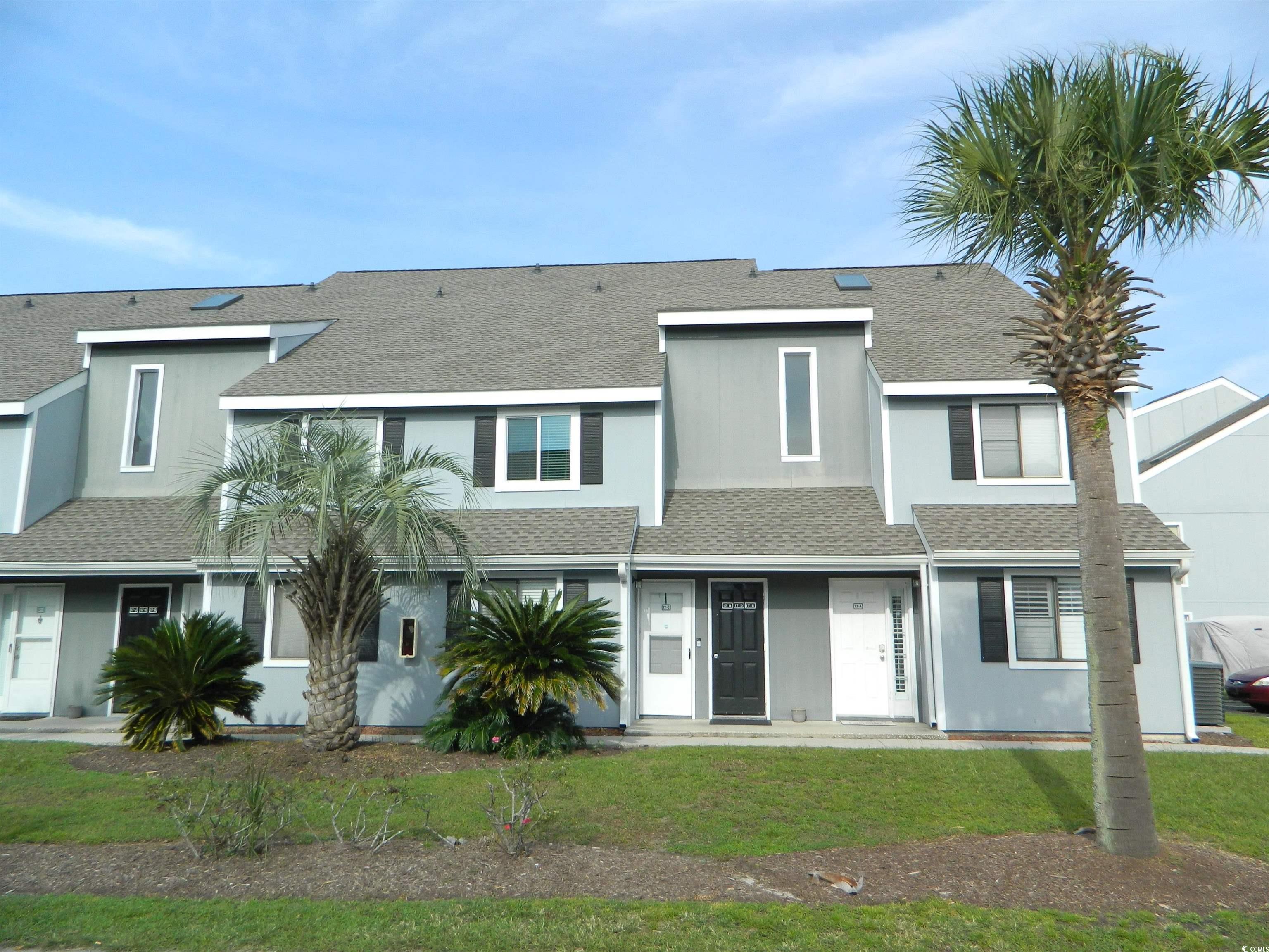 View of property with a front lawn