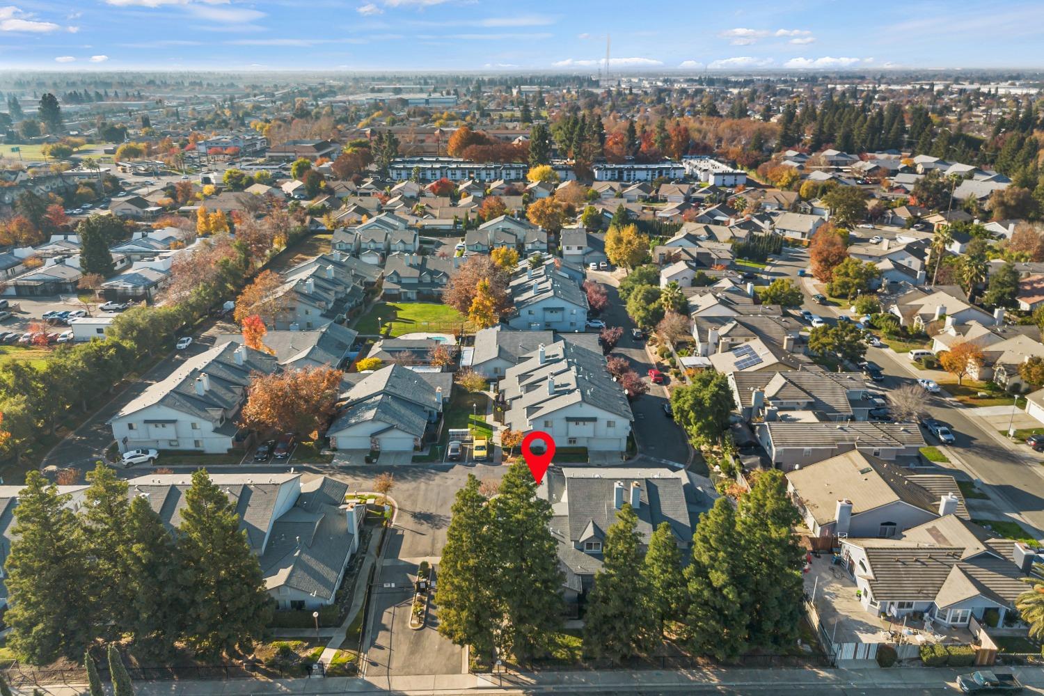 an aerial view of residential houses with city view