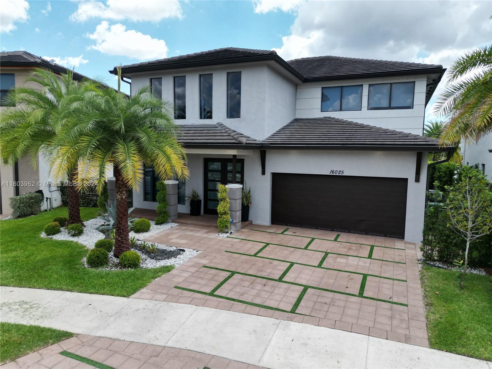 a front view of a house with garden