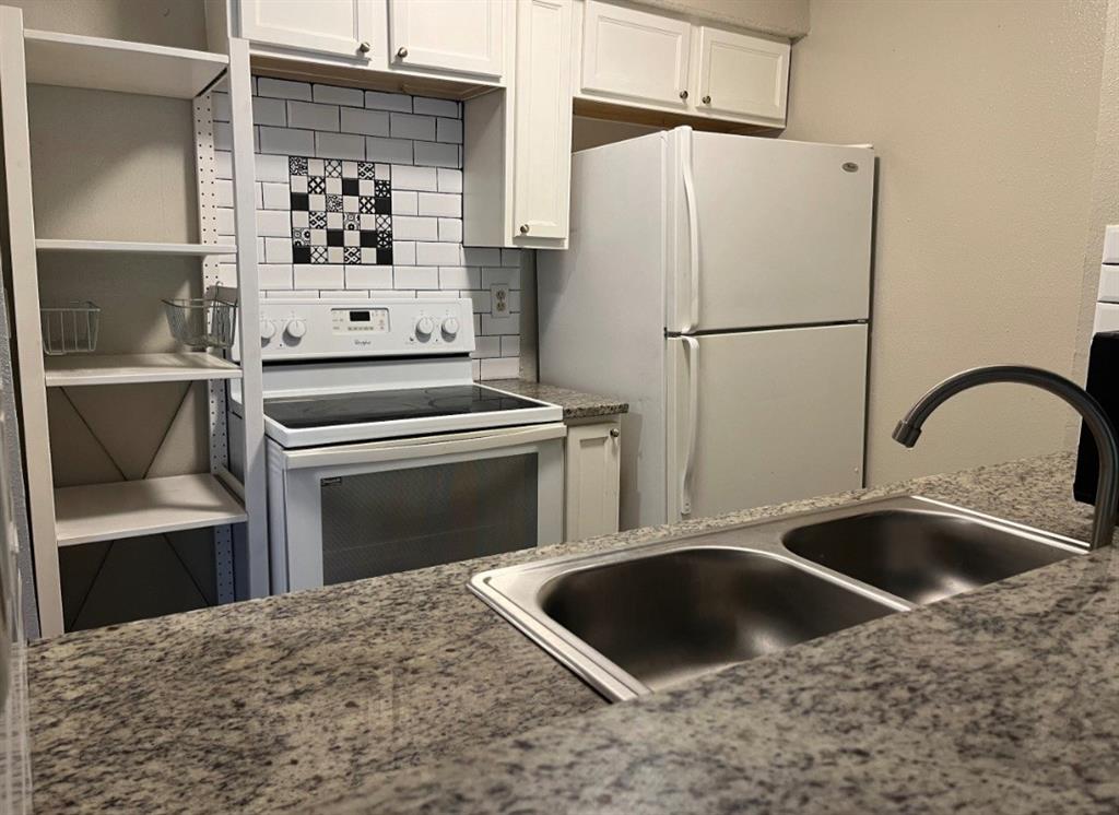 a kitchen with a stove and a refrigerator