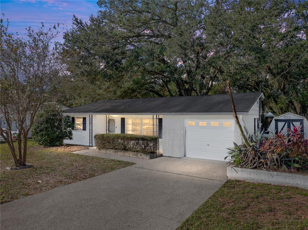 a view of a house with a yard and garage