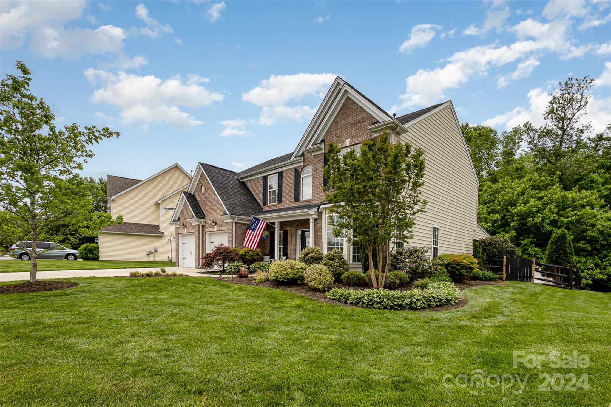 a front view of a house with a garden