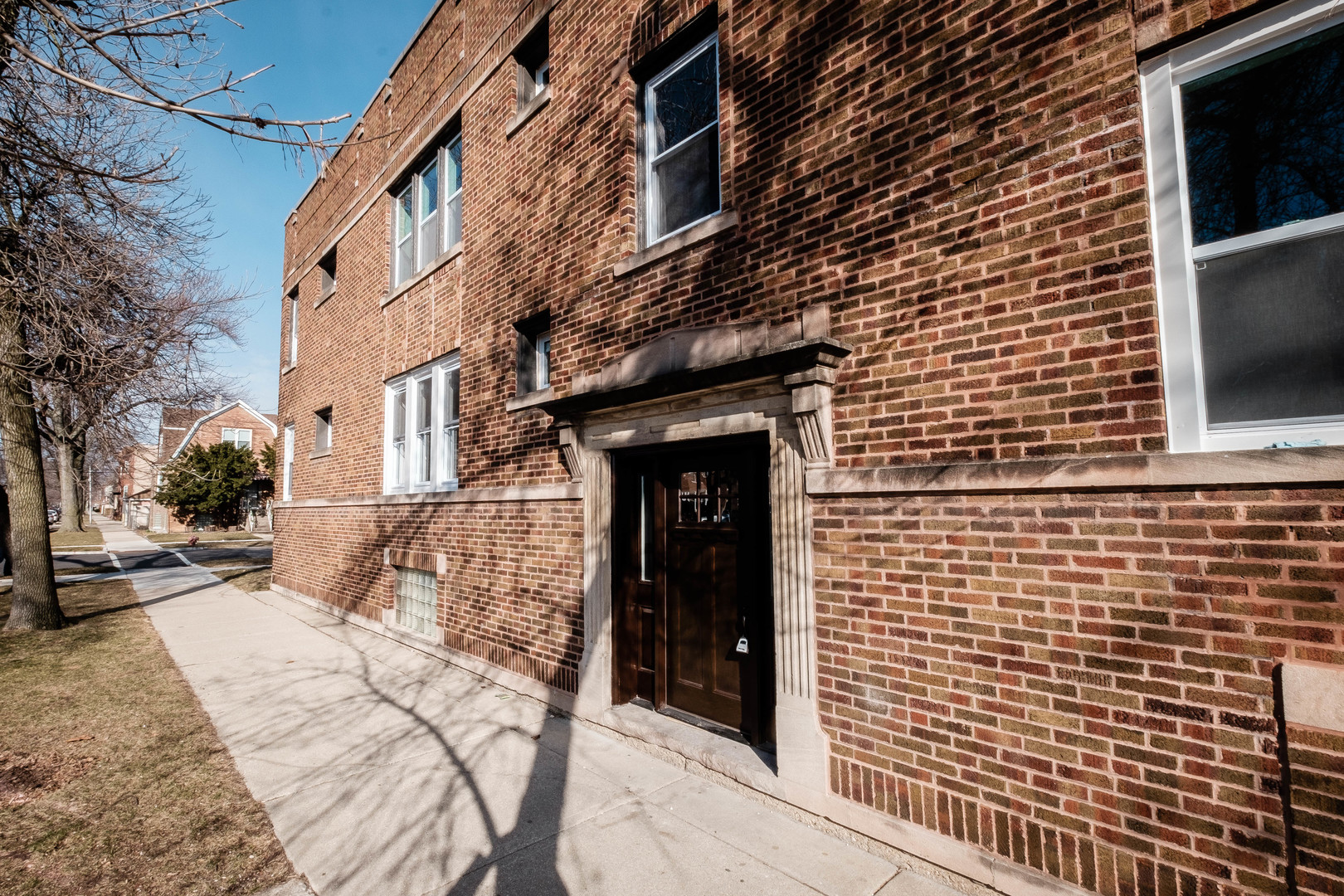 a view of a brick house with many windows