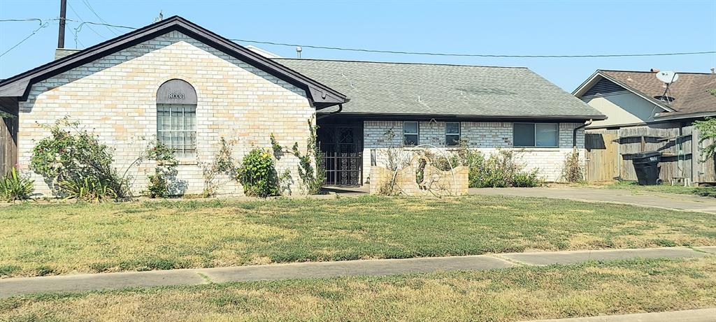 a view of a house with a yard and sitting area