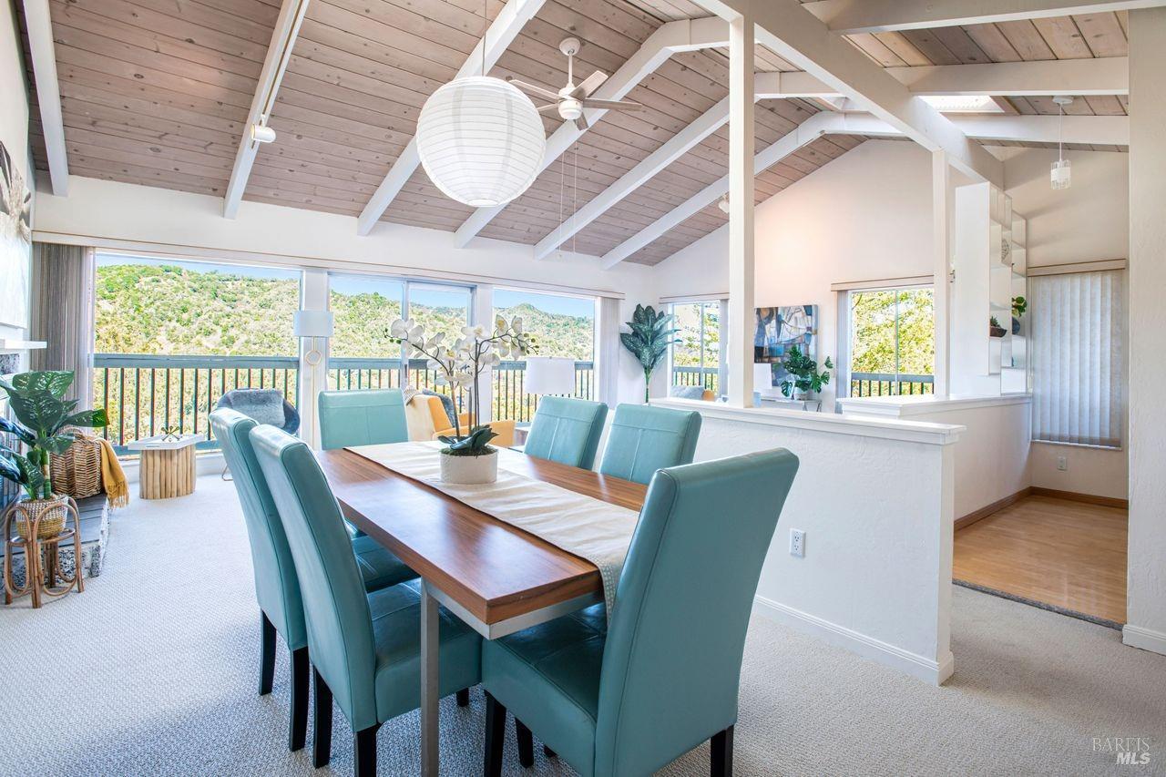 a view of a dining room with furniture a chandelier and wooden floor