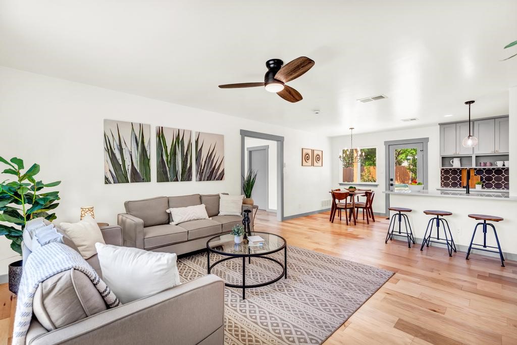 a living room with furniture and kitchen view