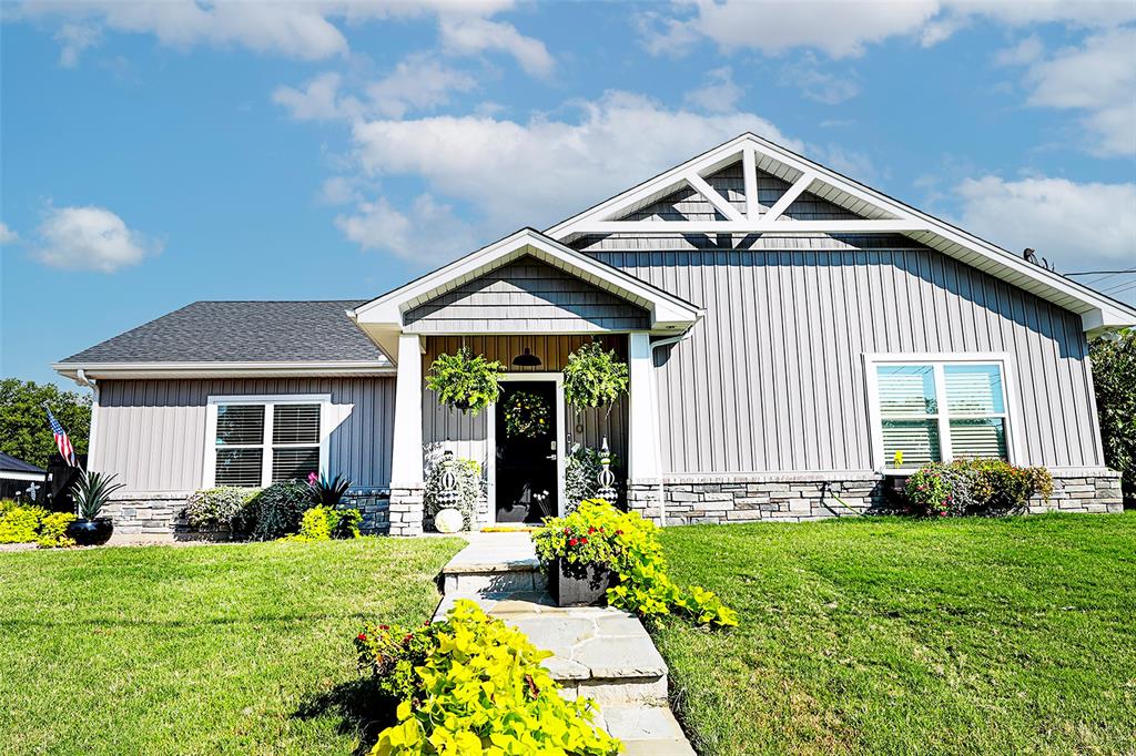 a front view of a house with garden