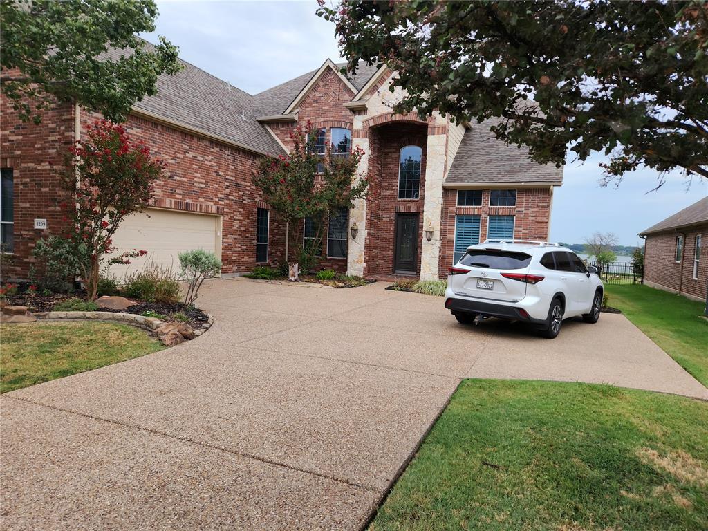 a car parked in front of a brick house