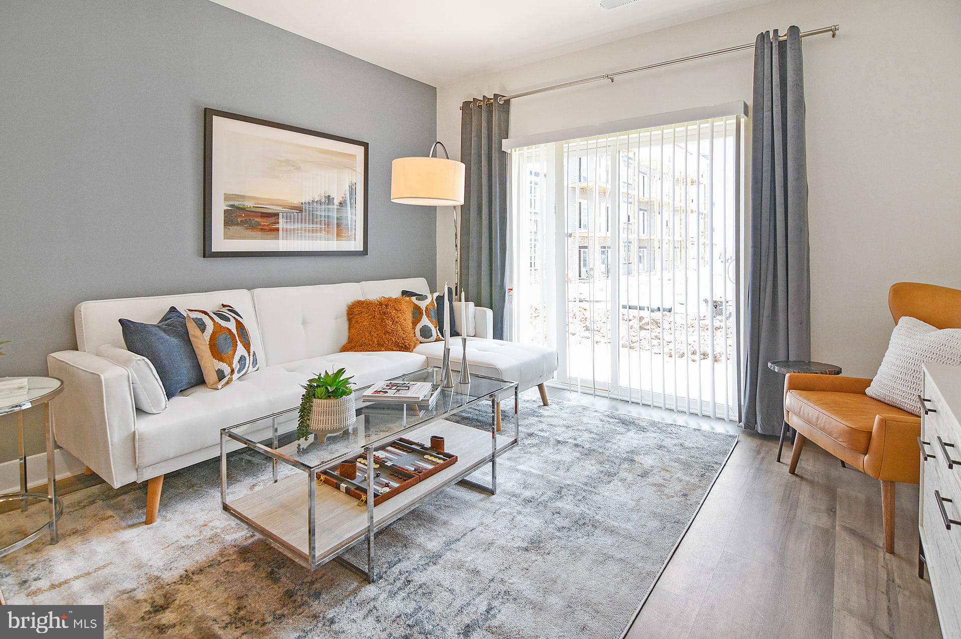 a living room with furniture and a window with outer view