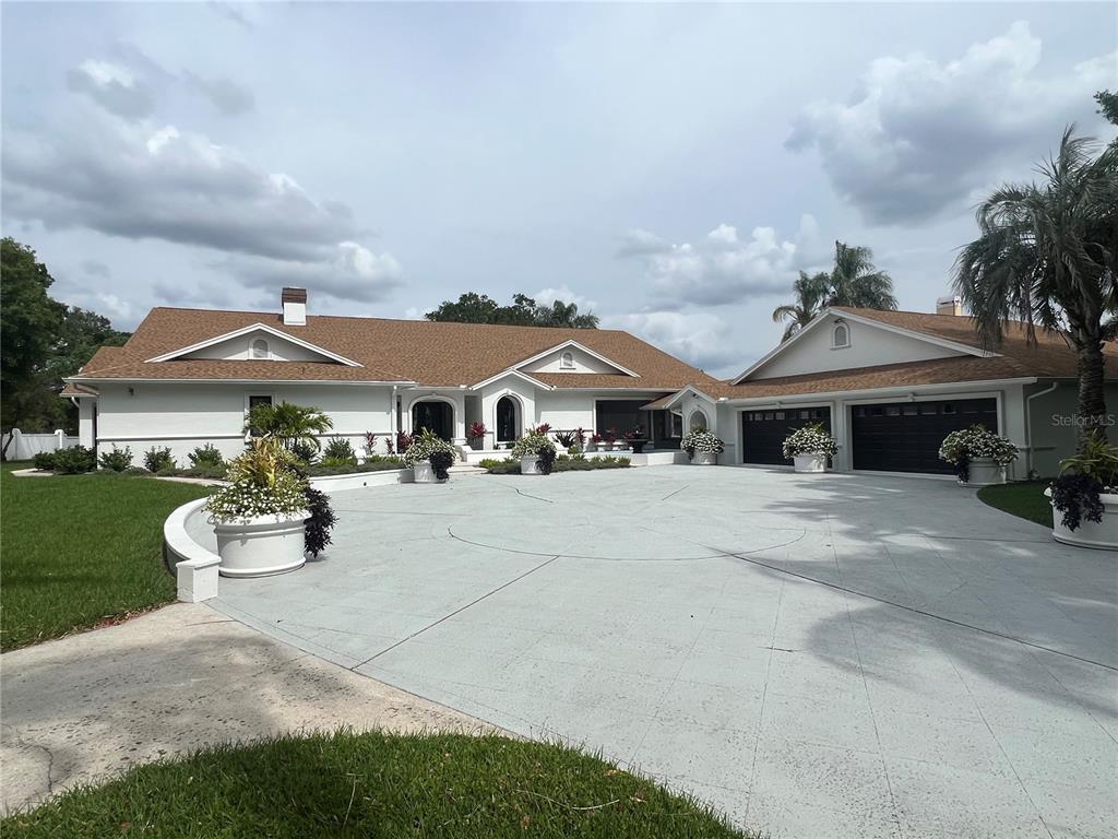 a front view of house with a garden