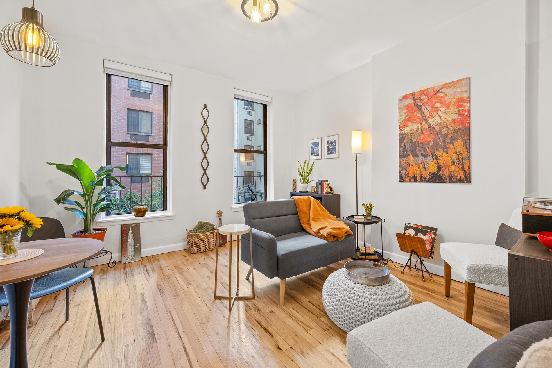 a living room with furniture and wooden floor