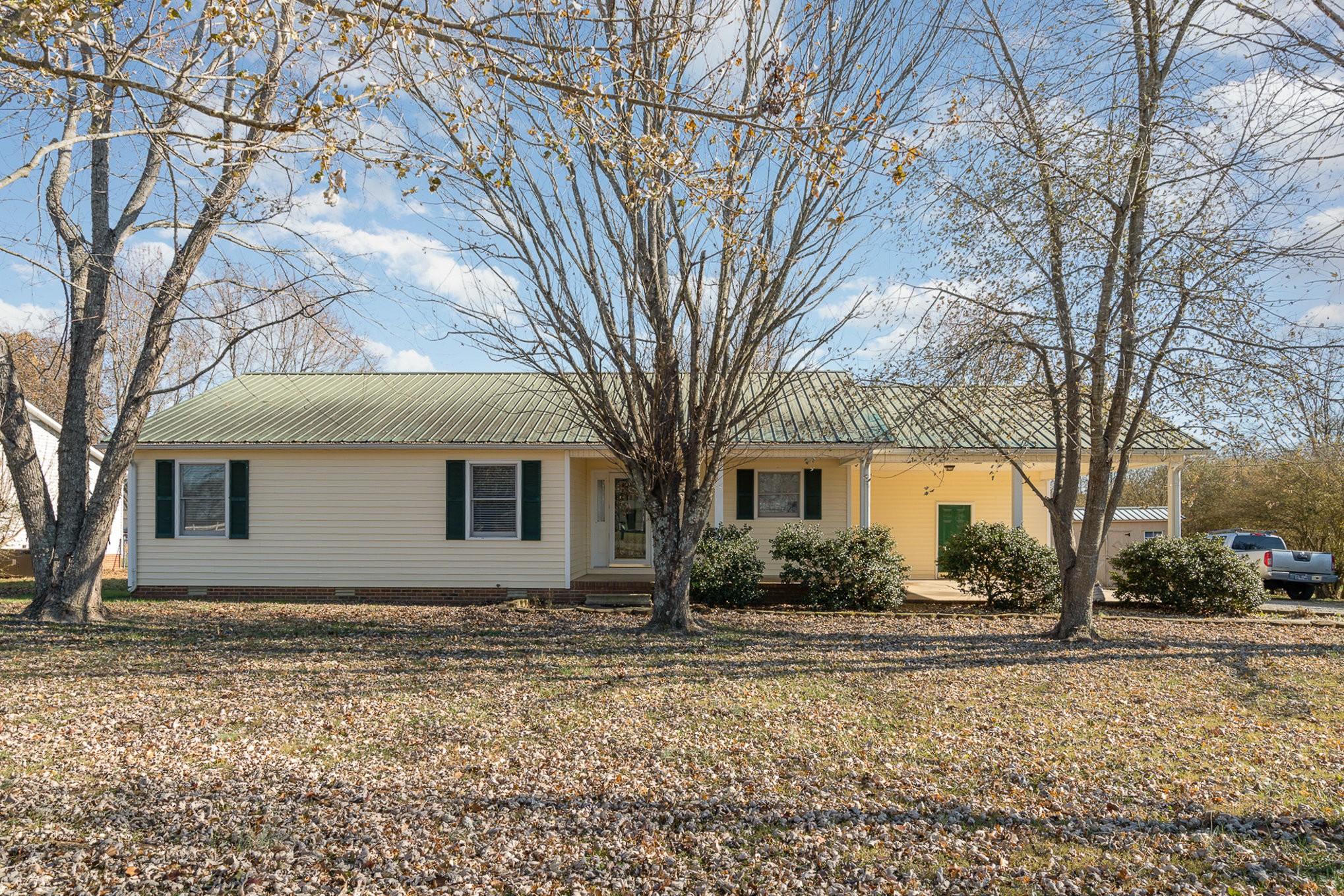 a house that has a tree in front of it