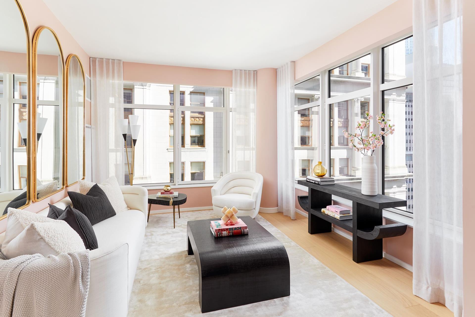 a living room with furniture and floor to ceiling windows