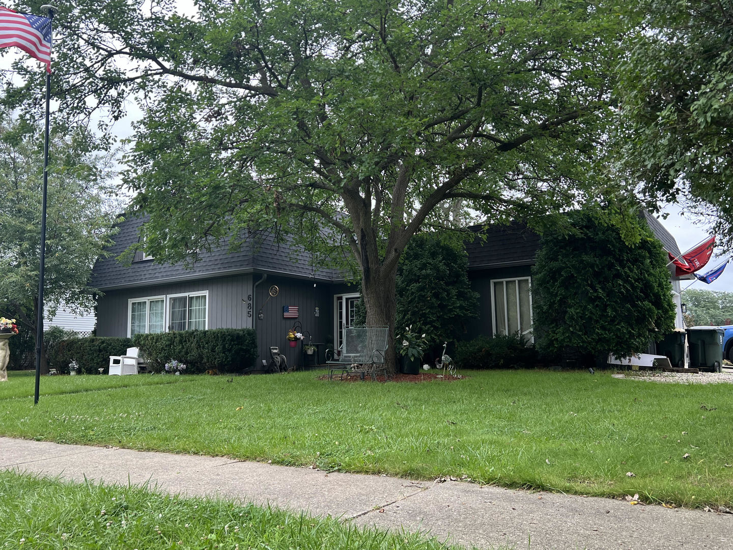 a view of house with yard and green space