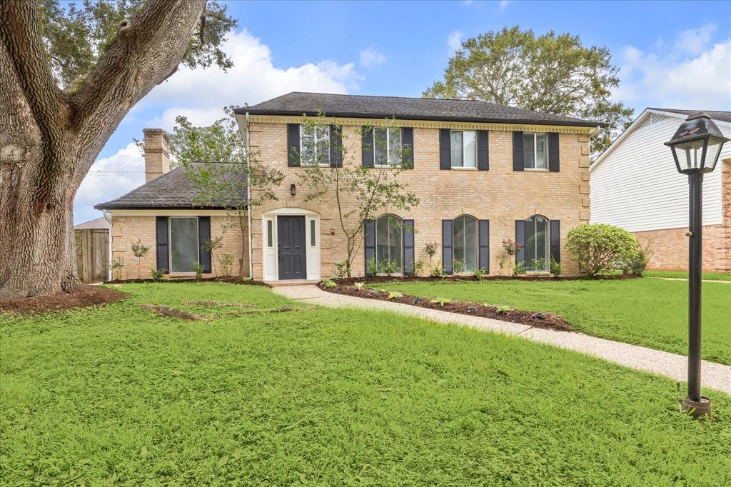 Colonial elevation on this custom built home.  Note the large set back offering long walkway and driveway