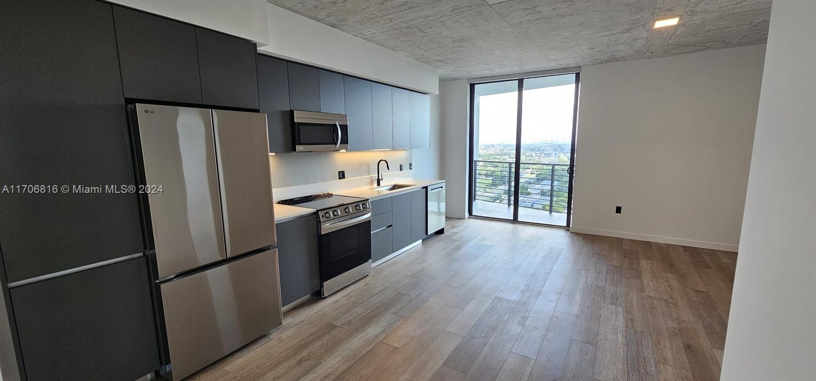 a kitchen with stainless steel appliances a refrigerator sink and cabinets